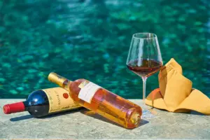 Bottles Of Wine Next To A Pool